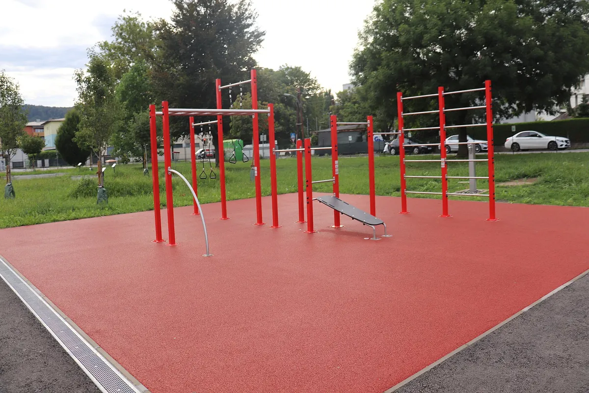 An outdoor calisthenics rig with pull-up bars at several heights